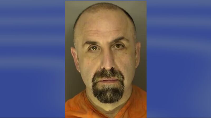 Former detective Michael DeBiase was booked on a felony charge of pointing and presenting a firearm at a person.