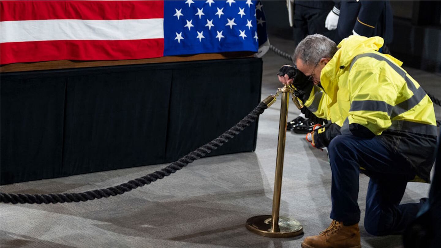 A mourner pays his respects at the casket of former President Jimmy Carter on Monday.