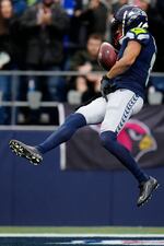 Seattle Seahawks cornerback Coby Bryant (8) intercepts the ball and runs for a touchdown during an NFL football game against the Arizona Cardinals, Sunday, Nov. 24, 2024 in Seattle. The Seahawks defeated the Cardinals 16-6. (AP Photo/Ben VanHouten)