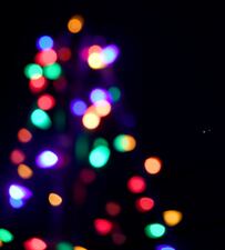 Jupiter (left) and Saturn appear about one-tenth of a degree apart during an astronomical event known as a Great Conjunction behind Christmas lights in the front yard of a house on December 21, 2020, in Las Vegas.
